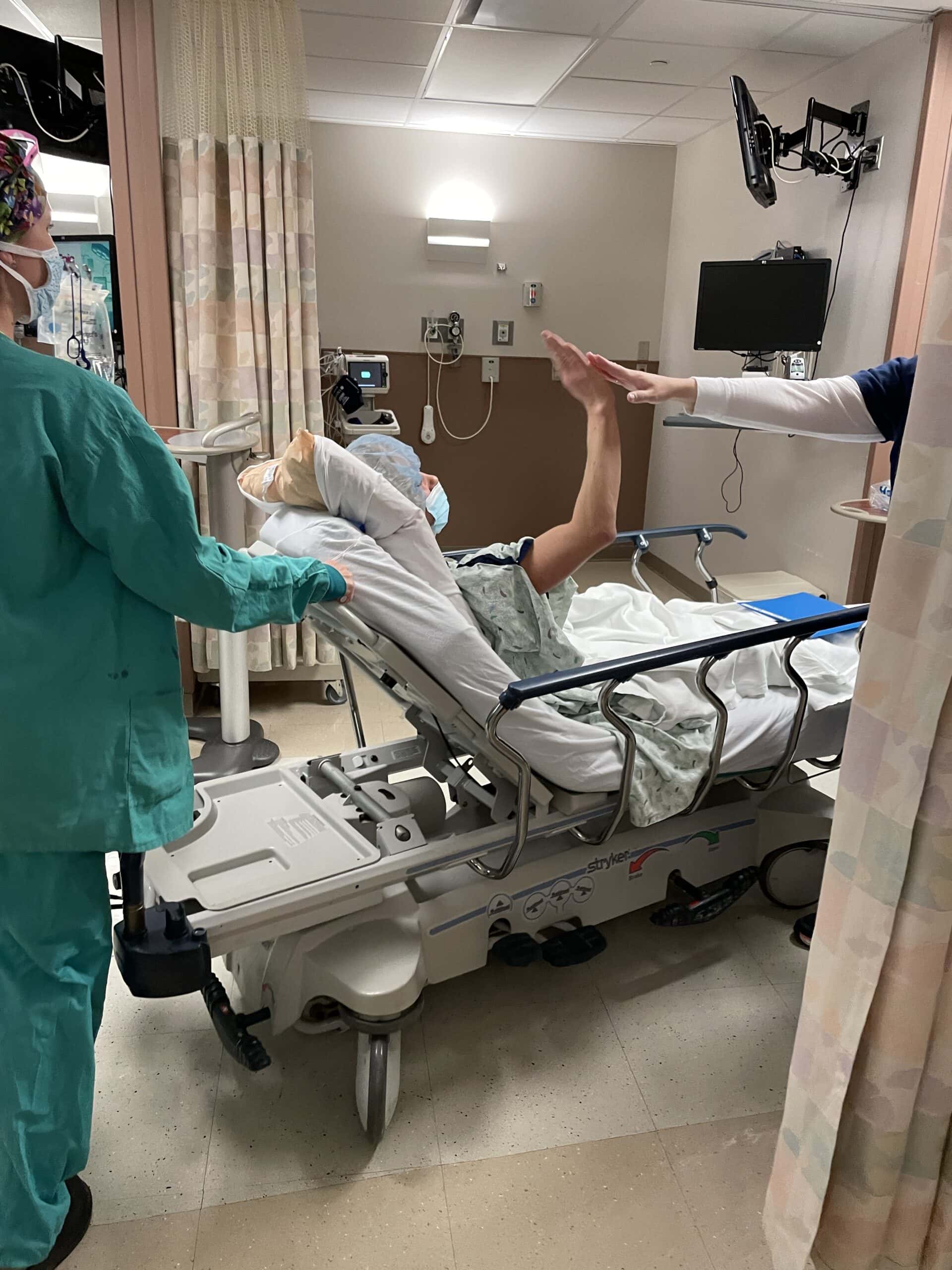 Breast Cancer Patient High Fiving Nurse and Doctors